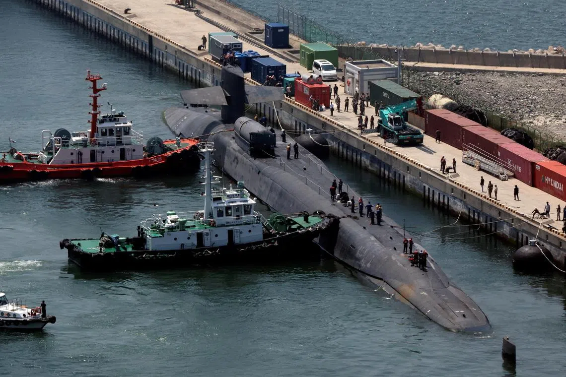 Ohio-class U.S. nuclear-powered submarine USS Michigan (SSGN 727)  anchored at a port in Busan, South Korea, on June 16, 2023.   