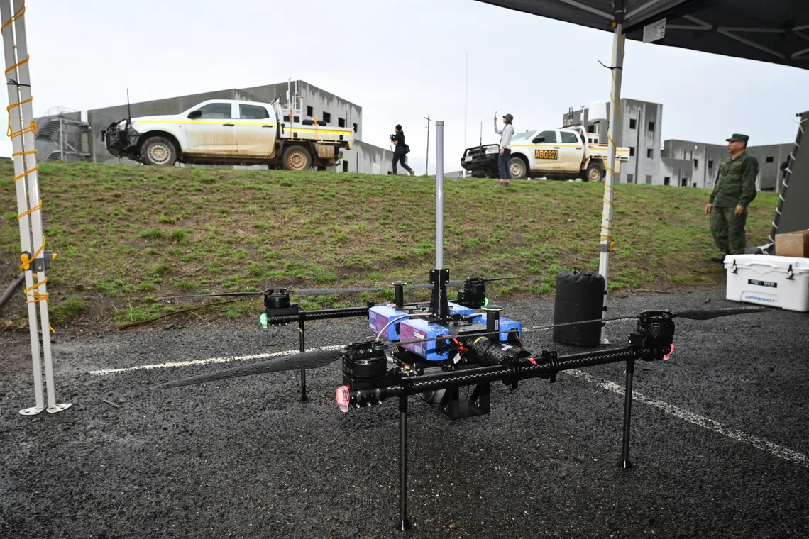 5G area communications node (ACN) drone (bottom) with SAF’s mobile Counter-Unmanned Aerial System (C-UAS) in the background, at the Urban Operations Training Facility (UOTF) in the Shoalwater Bay Training Area in Queensland, Australia on Oct 23.