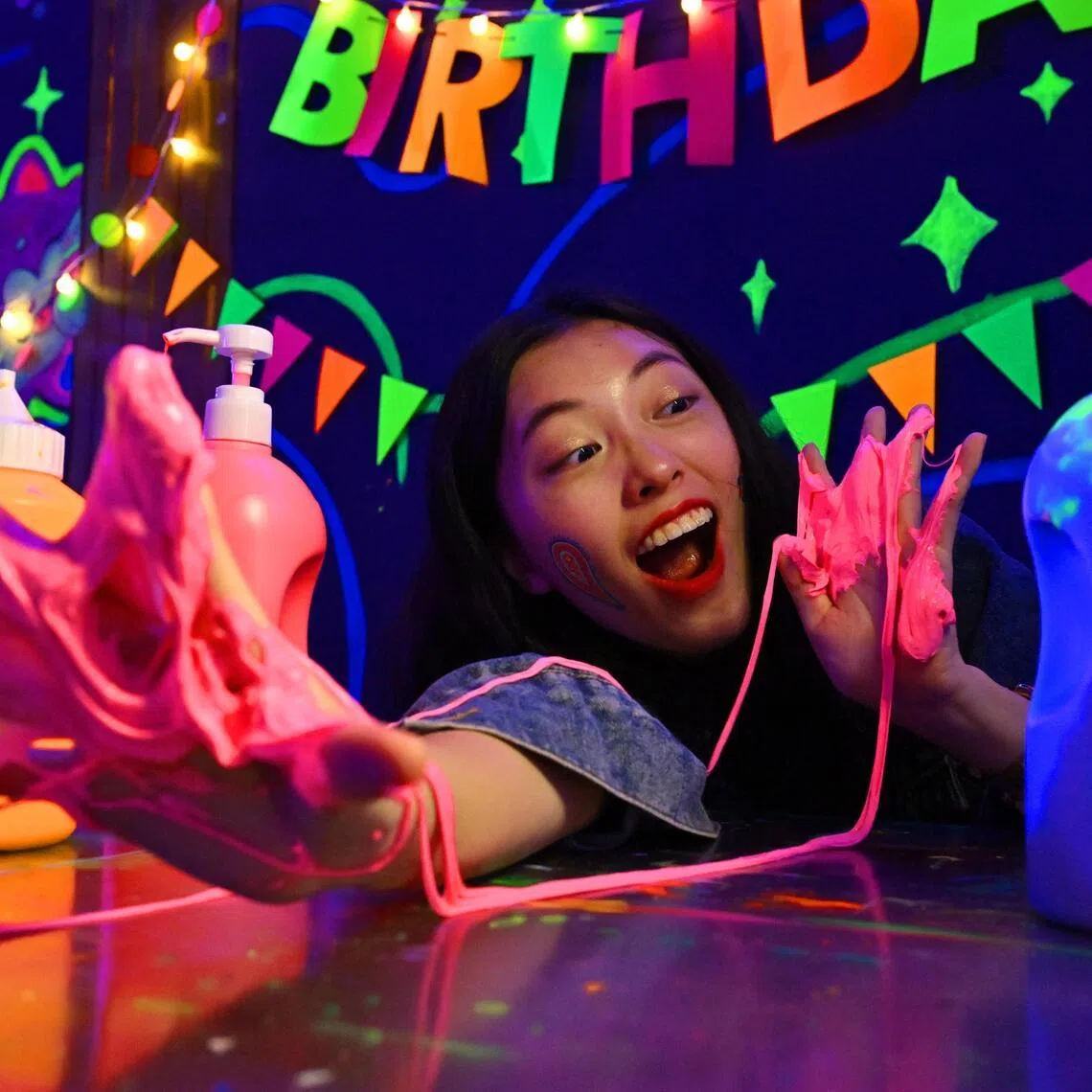 Ms Merida Lim showing off glow-in-the-dark slime, which customers can make at Scuro.