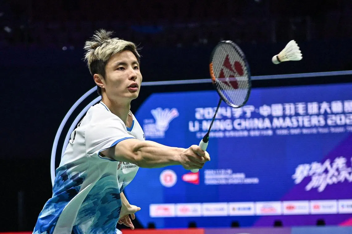 China's Shi Yuqi hits a return to Thailand's Kunlavut Vitidsarn during the men's singles quarterfinal match of the BWF World Tour China Masters 2024 badminton tournament in Shenzhen, in southern China's Guangdong province on November 22, 2024. (Photo by AFP) / China OUT