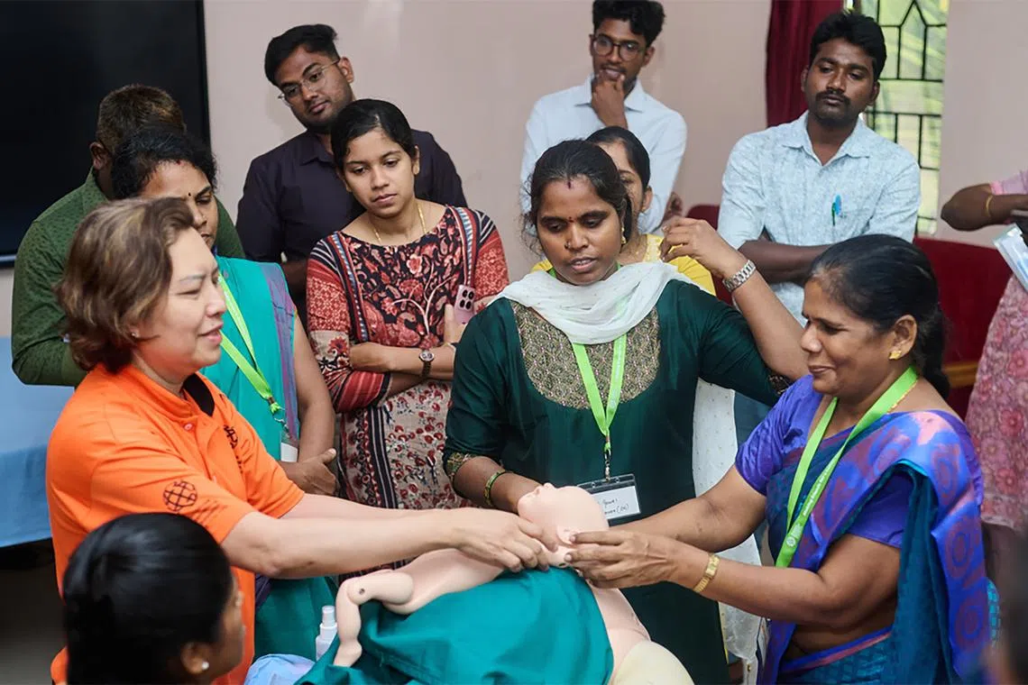 stvolunteering - Senior Nurse Clinician Maria Binte Jumhasan (in orange), a Singapore International Volunteer, demonstrates how to manage a breech delivery at a district hospital in Chennai, Tamil Nadu. (Photo: Singapore International Foundation) Copyright: ST