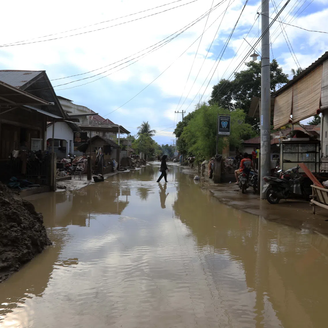 A road is covered in water in a flood-affected village in Indonesia on Dec 2.