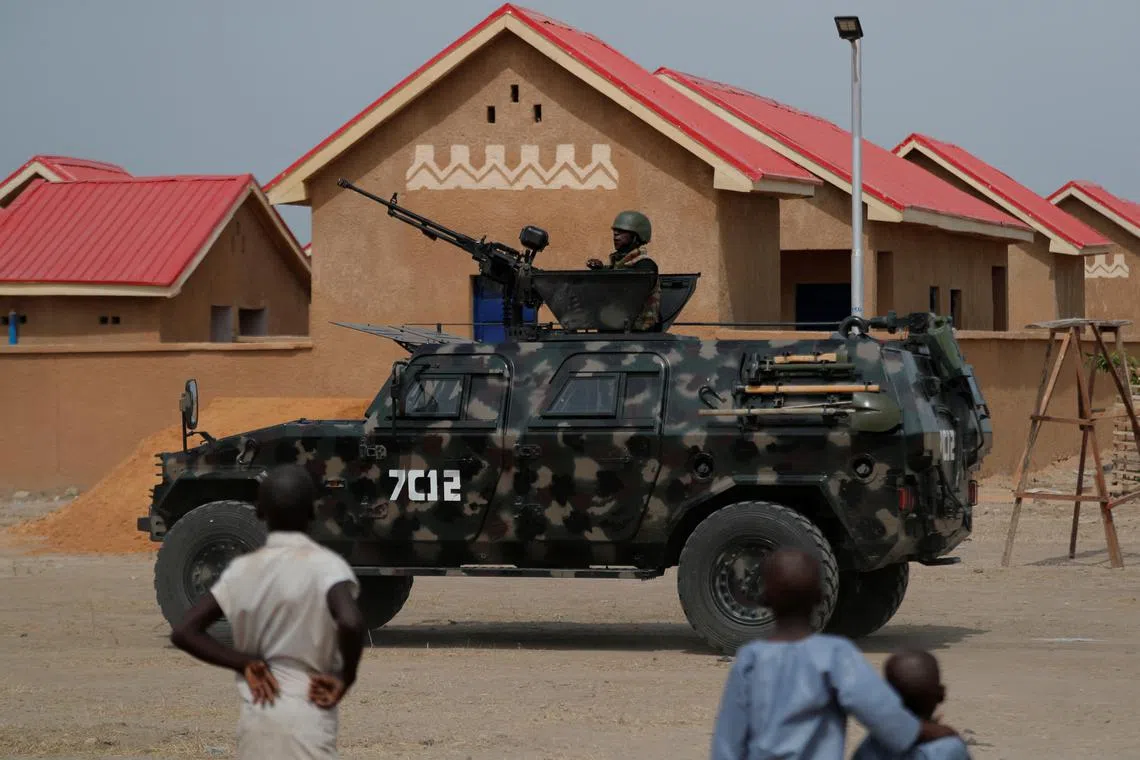 FILE PHOTO: An armored vehicle of Nigerian Security Forces drives by newly built homes in Ngarannam, Borno State, Nigeria, October 21, 2022. REUTERS/Christophe Van Der Perre/File Photo