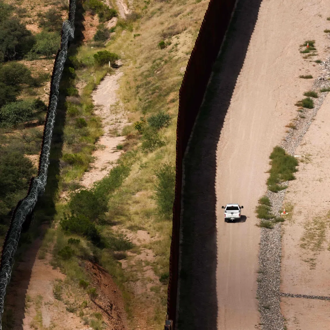 A US Customs and Border Protection (CBP) vehicle patrols along the US-Mexico border in Nogales, Arizona.