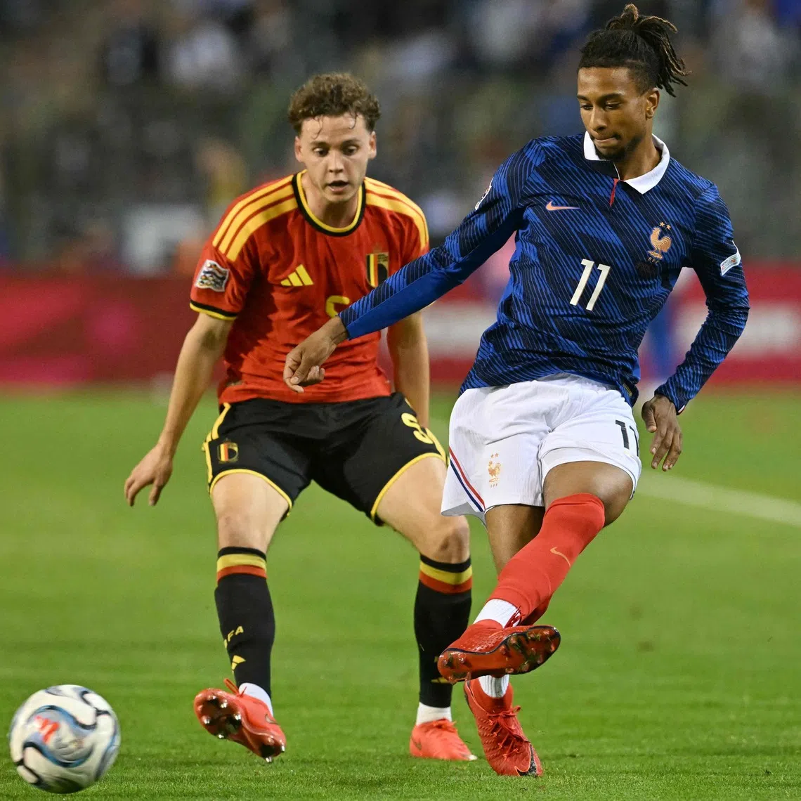 France’s Michael Olise (right) passes the ball in front of Belgium’s defender Maxim De Cuyper during the UEFA Nations League match at King Baudouin Stadium in Brussels, on Sept 28.