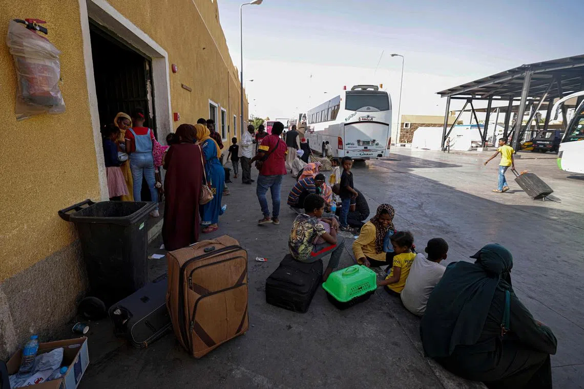 Passengers fleeing war-torn Sudan arrive at Qastal Lan Port crossing between Egypt and Sudan on Saturday. 