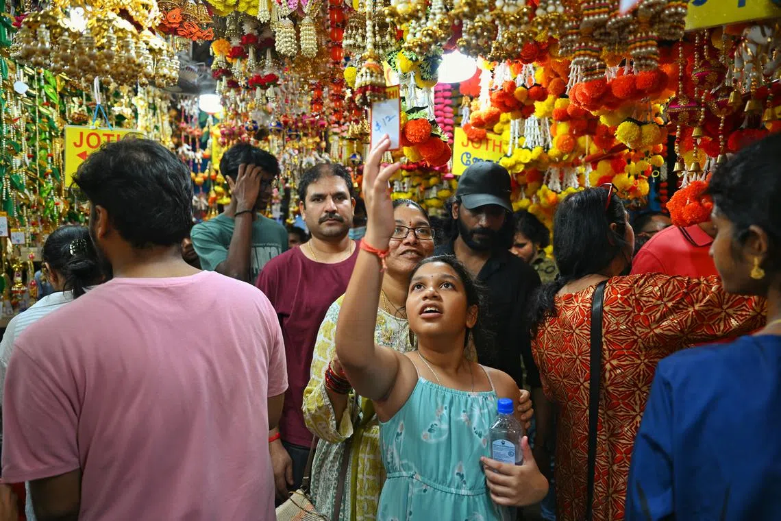 Yerra Rajasekhar,43, his wife Haritha, 37 and daughter, Saanvi, 10 doing last-minute shopping at a bazaar at Campbell Lane on Nov 11, 2023.