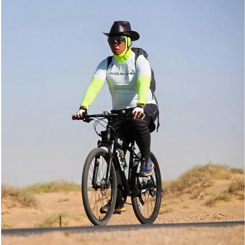 Rich Liow on his mountain bike during the Gobi Desert trip in May 2026 (left) and during his trip to Everest base camp in 2023.
