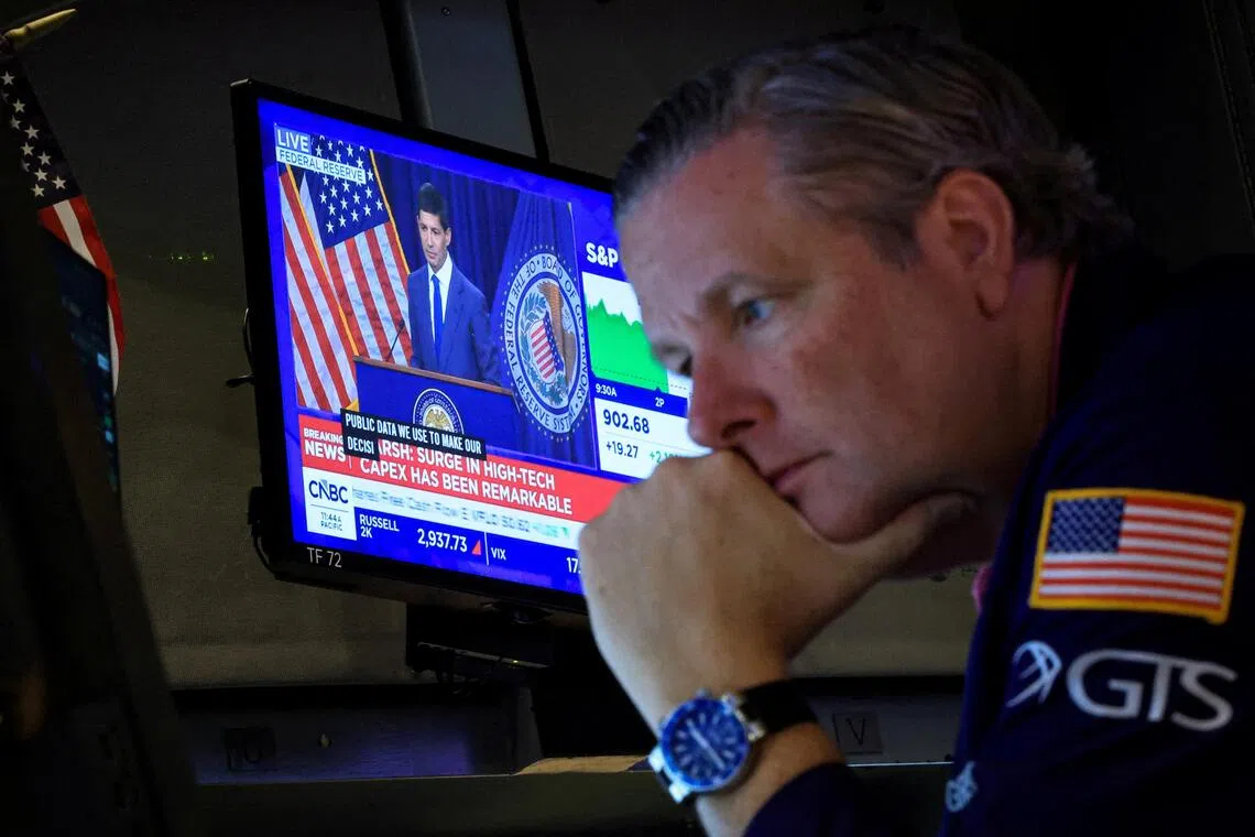 A trader working at the New York Stock Exchange on July 29, as a screen broadcasts a press conference by US Federal Reserve chairman Kevin Warsh following the Fed’s latest rate announcement.