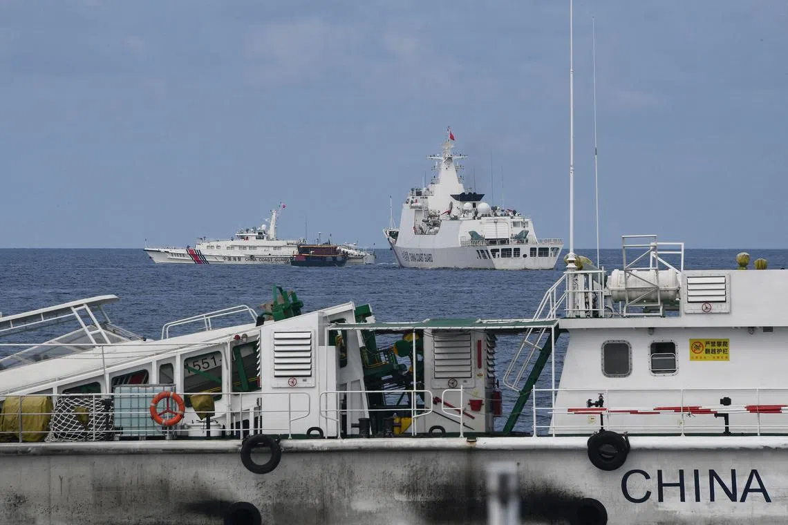 Chinese coast guard ships are seen in this Aug 22, 2023 file photo corralling a Philippine resupply boat.