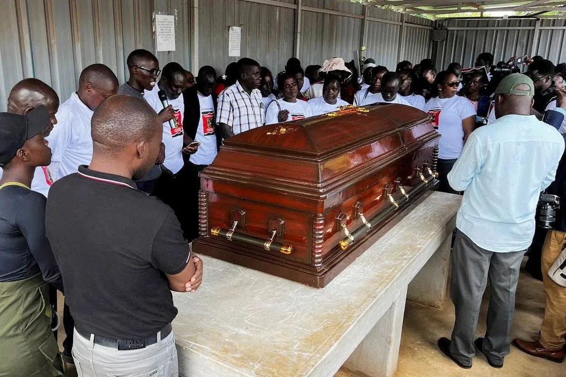 Family members mourn and react next to the coffin of the slain Olympian Rebecca Cheptegei, who died after her former boyfriend doused her in petrol and set her ablaze, at the Moi Teaching & Referral Hospital (MTRH) funeral home, in Eldoret, Kenya September 13, 2024. REUTERS/Edwin Waita
