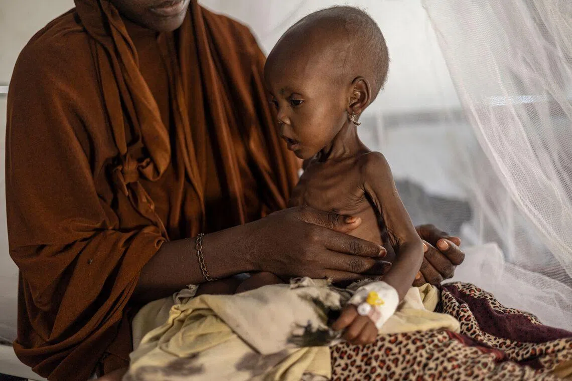 A newly displaced Somali woman holding her severely malnourished baby in a stabilization centre for children suffering severe accute malnutrition in Kismayo, on April 22. 