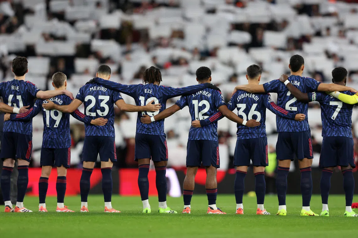 Arsenal players during a minute's silence as part of remembrance commemorations before the match against Sunderland on Nov 8.