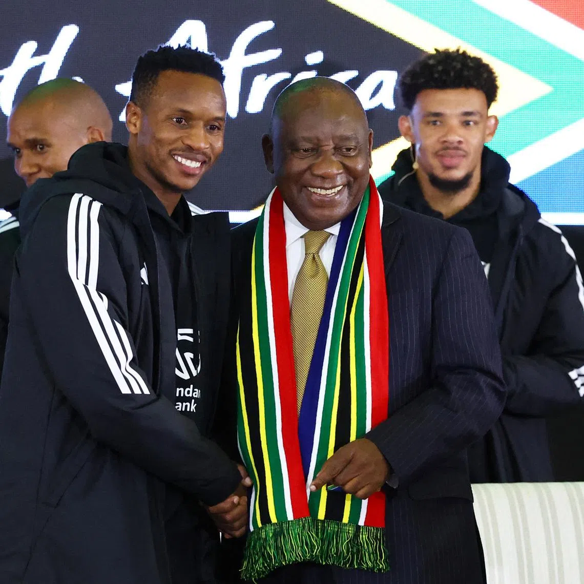 Soccer Football -FIFA World Cup 2026 - South Africa coach Hugo Broos announces his World Cup squad - Sefako Makgatho Presidential Guest House, Pretoria, South Africa - May 27, 2026  South Africa's Themba Zwane shakes hands with South Africa president Cyril Ramaphosa during the squad announcement REUTERS/Siphiwe Sibeko
