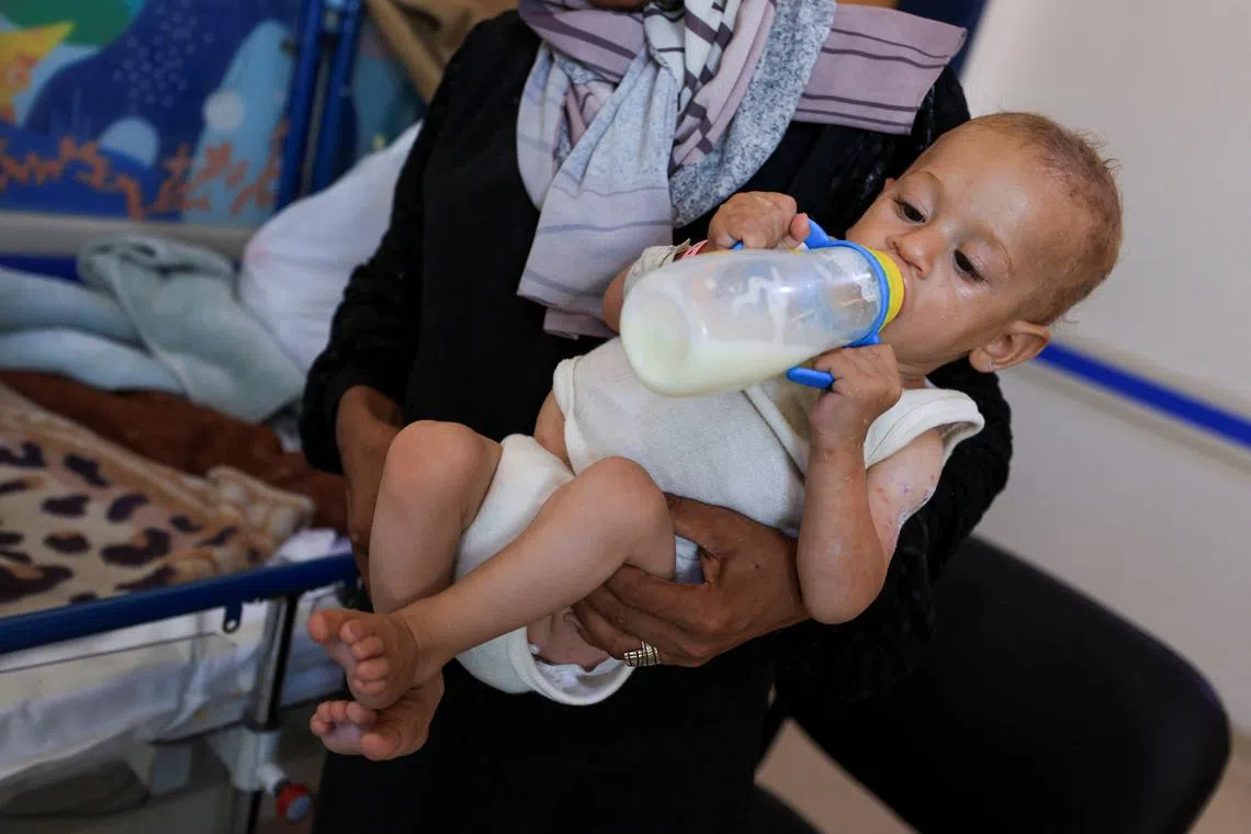 Aisha Wahdan, mother of 8-month-old Hatem, who is being treated for malnutrition, feeds him milk at Al-Rantisi Hospital, amid severe shortages of infant formula, in Gaza City, August 7, 2025. REUTERS/Dawoud Abu Alkas