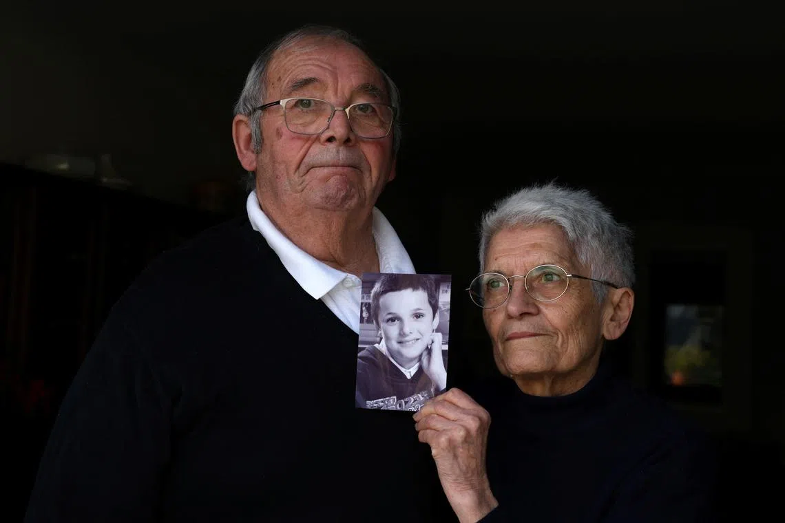 Roland and Mauricette Vinet hold a photo of their grandson Mathis Vinet at their home in Saint-Germain near Poitiers, before the opening of the trial in Vannes of French ex-surgeon Joel Le Scouarnec, accused of the aggravated rape and sexual assault against hundreds of children during three decades, France, February 5, 2025. REUTERS/Manuel Ausloos