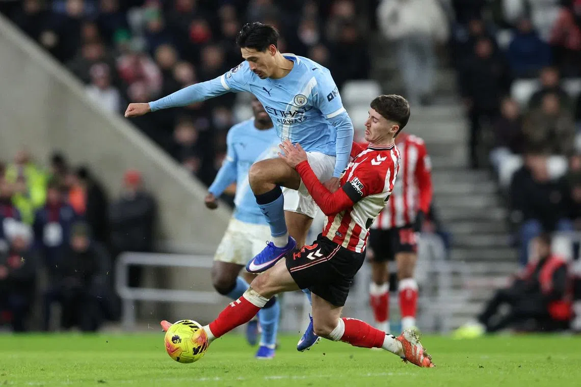 Soccer Football - Premier League - Sunderland v Manchester City - Stadium of Light, Sunderland, Britain - January 1, 2026 Manchester City's Tijjani Reijnders in action with Sunderland's Trai Hume REUTERS/Scott Heppell