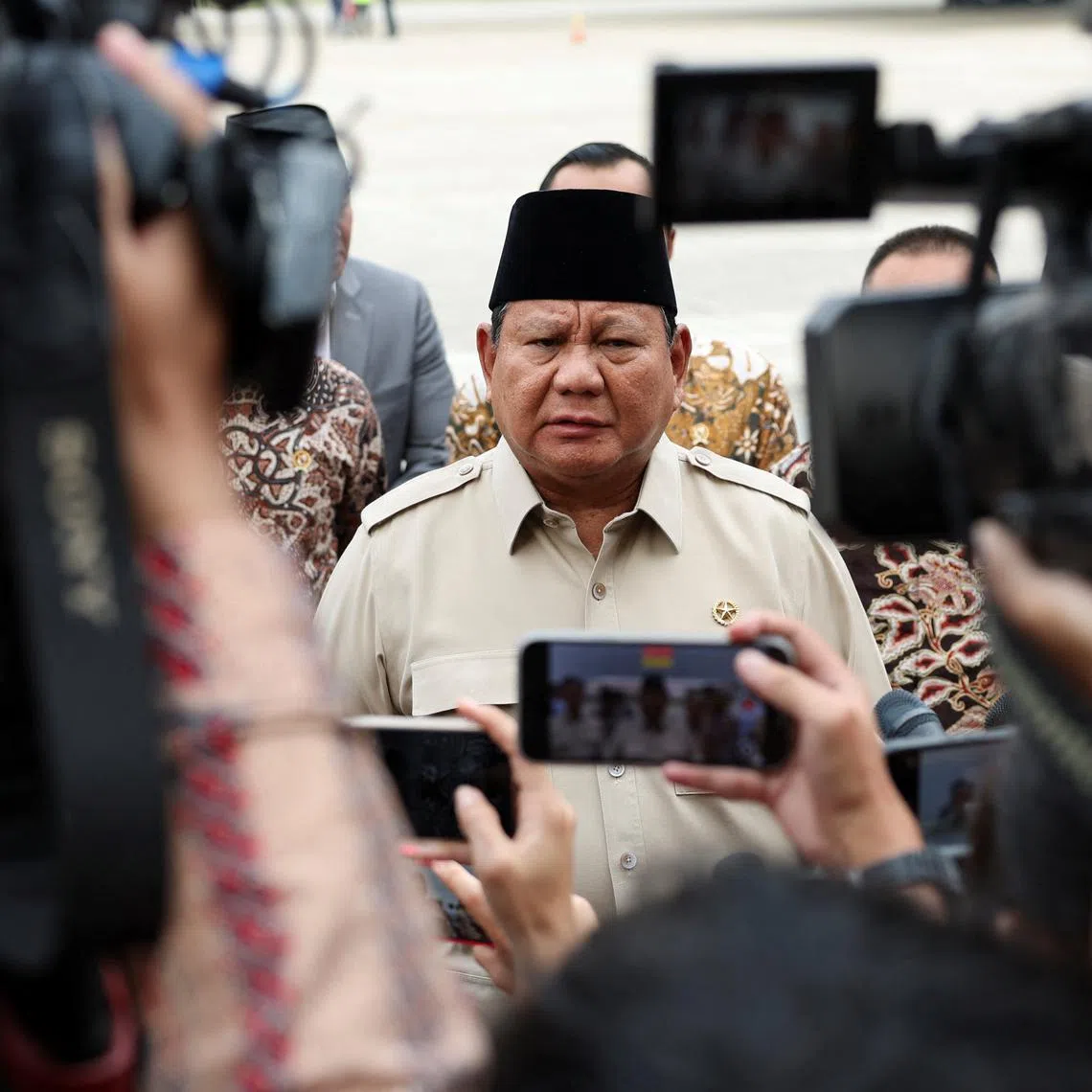 FILE PHOTO: Indonesian President Prabowo Subianto speaks to members of the media after his arrival at the Halim Perdanakusuma military airbase, following a trade deal with the United States after negotiations, which resulted in a reduction of proposed U.S. tariff rates on the country's exports to 19% from 32%, in Jakarta, Indonesia July 16, 2025. REUTERS/Ajeng Dinar Ulfiana/File Photo