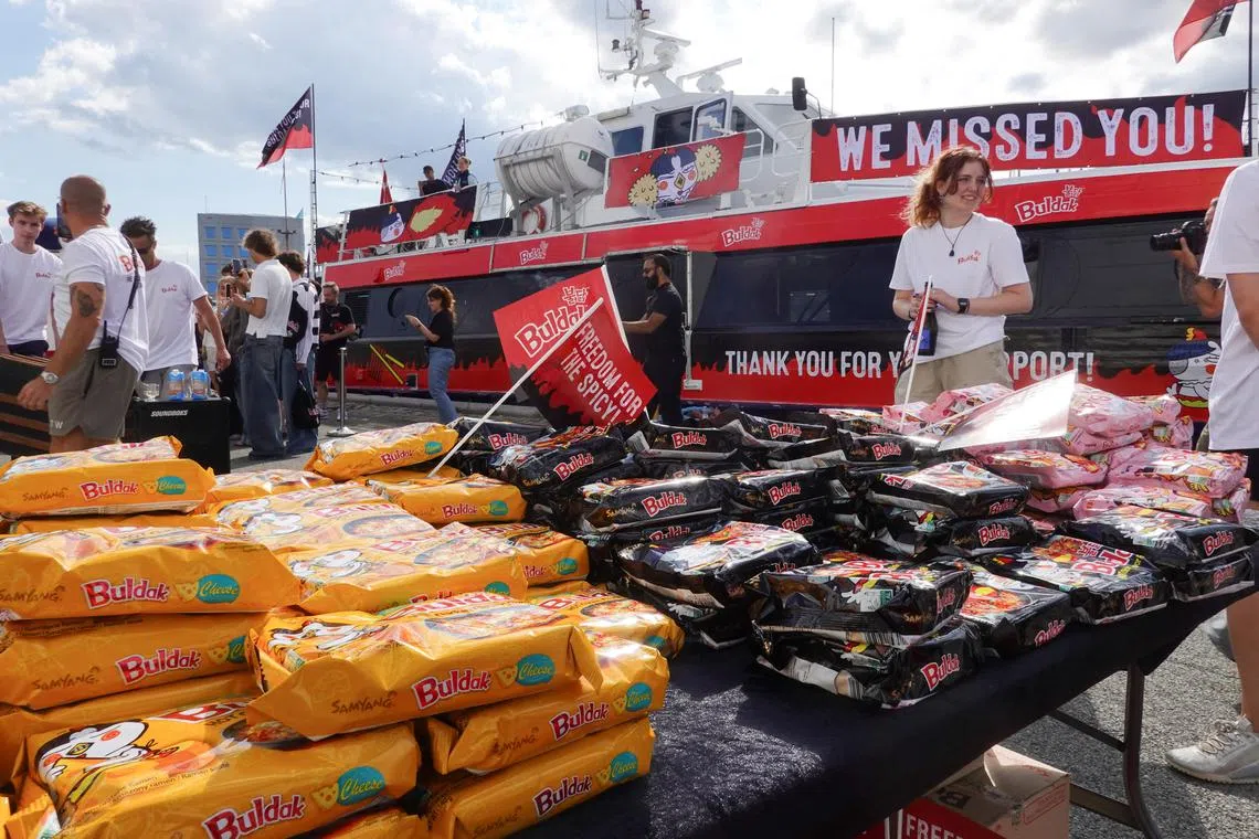 Packets of Buldak ramen are seen by a boat prepared for a press event in central Copenhagen on Aug 8. 