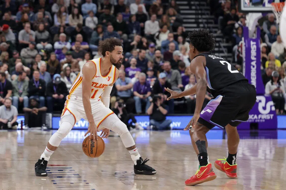 Atlanta Hawks guard Trae Young keeps the ball from Utah Jazz guard Collin Sexton during the second quarter at Delta Centre. 