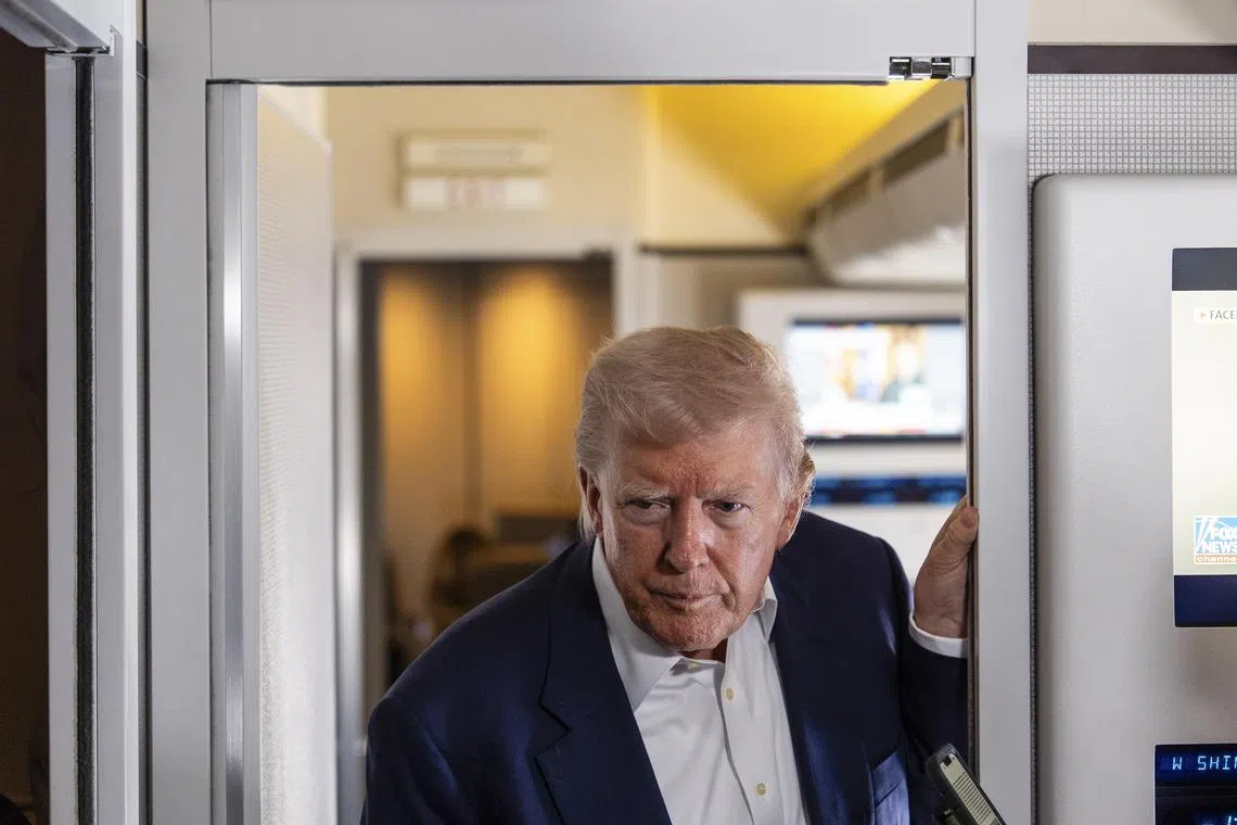 President Donald Trump speaking to reporters aboard Air Force One, as he travels to Italy for the funeral of Pope Francis, on April 25.
