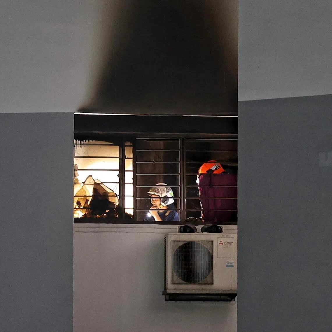 Footage provided by a resident shows a blackened exterior wall above the bedroom window of a flat at Tampines Street 21 that caught fire on Feb 19.
