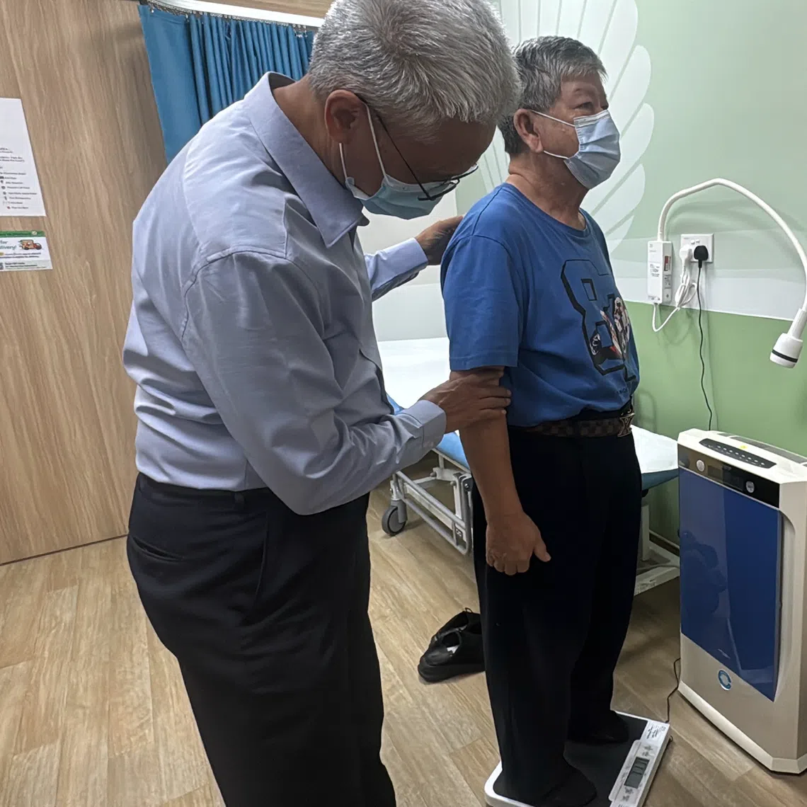 Clinical Associate Professor Tan Ngiap Chuan, director of research and the Primary Care Research Institute under SingHealth Polyclinics, attending to a patient on bone health.
