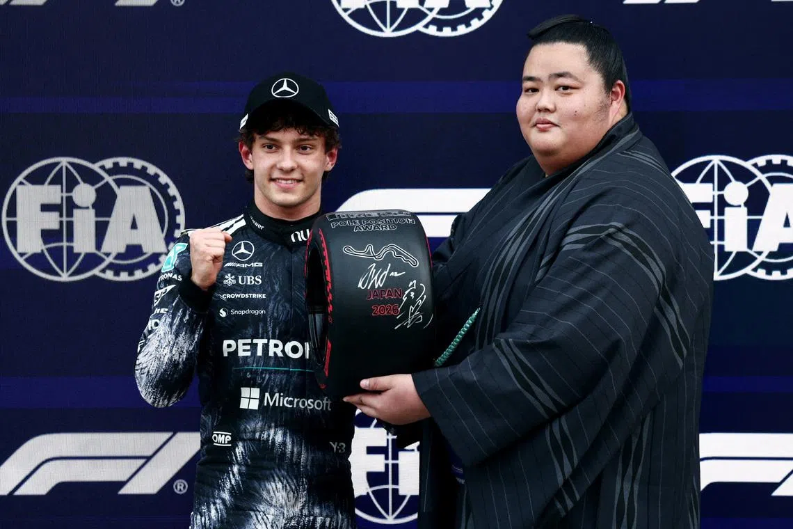 Formula One F1 - Japanese Grand Prix - Suzuka Circuit, Suzuka, Japan - March 28, 2026 Sumo Wrestler Ozeki Kotozakura presents the pole position award to Mercedes' Andrea Kimi Antonelli after qualifying in pole position REUTERS/Jakub Porzycki