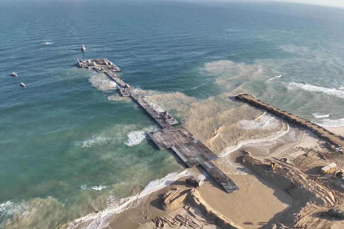 FILE PHOTO: Ships are seen near a temporary floating pier built to receive humanitarian aid in the Gaza Strip in Gaza Beach, in this handout picture obtained by Reuters on May 18, 2024. Israel Defense Forces/Handout via REUTERS/File Photo
