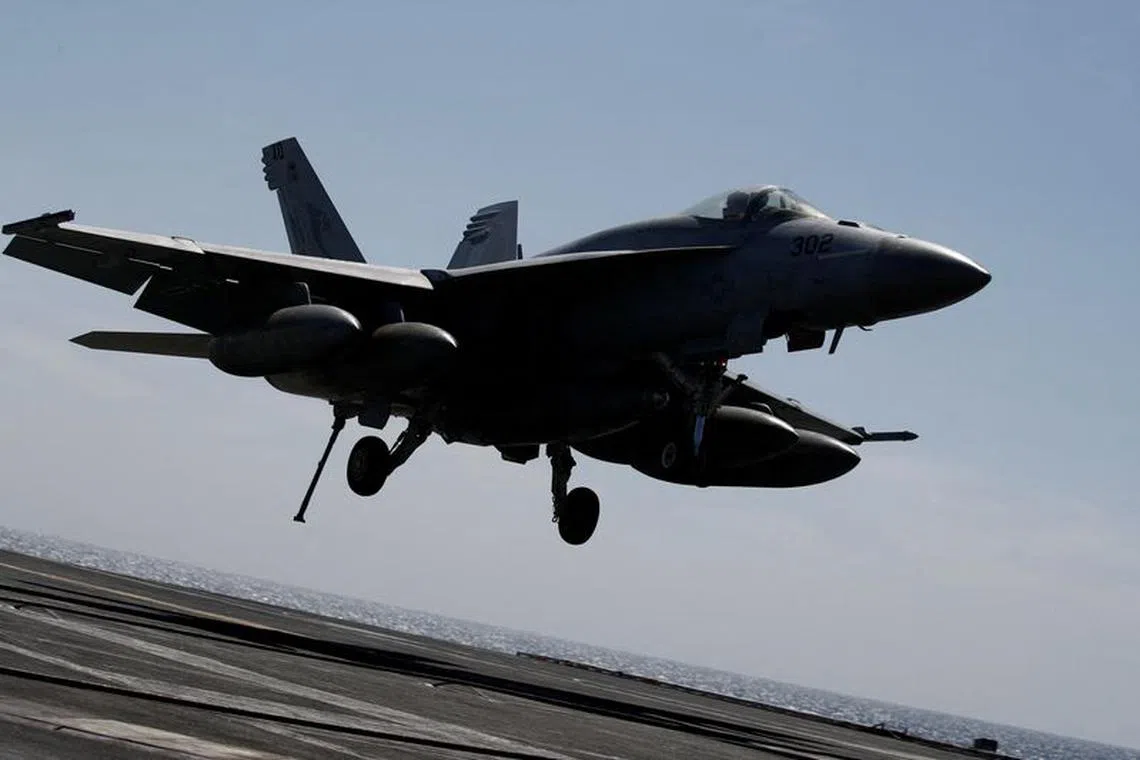 A U.S. navy F-18 Super Hornet lands on the flight deck on the USS Nimitz, off the coast of Busan, South Korea, 27 March, 2023. The ROK-US combined maritime exercise is a part of Warrior Shield. Jeon Heon-Kyun/Pool via REUTERS/File Photo