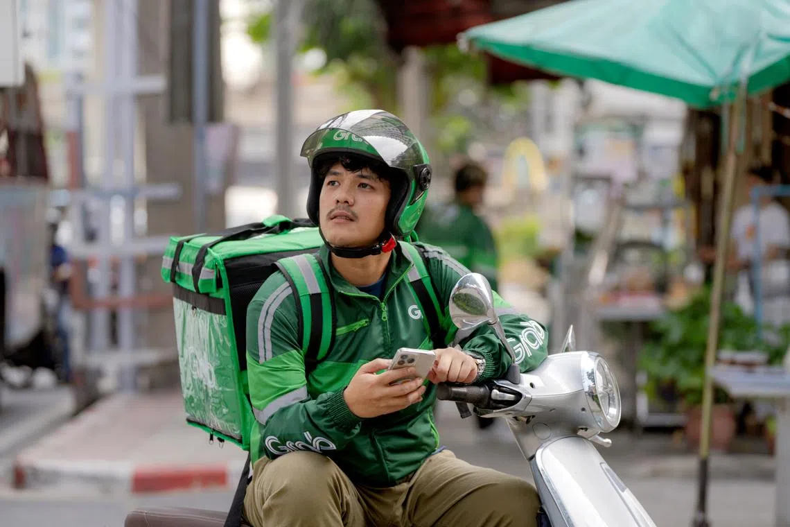 grab rider waiting for food delivery order will enjoy more healthcare and wellness benefits in 2025 grabbenefits 2.0 programme