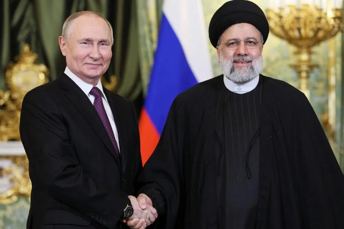 FILE PHOTO: Russian President Vladimir Putin shakes hands with Iranian President Ebrahim Raisi during a meeting in Moscow, Russia December 7, 2023. Sputnik/Sergei Bobylev/Pool via REUTERS