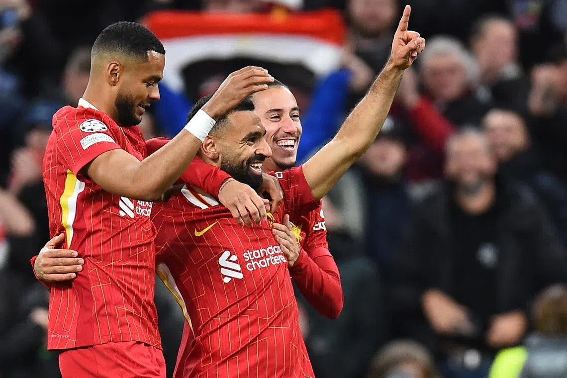 Liverpool's Mohamed Salah (centre) celebrates with teammates after scoring his team's second goal.