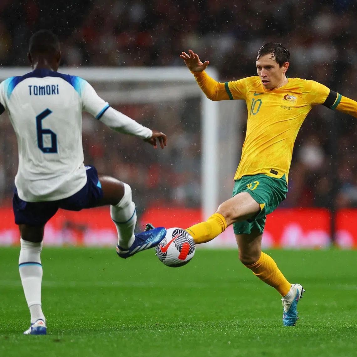 Soccer Football - International Friendly - England v Australia - Wembley Stadium, London, Britain - October 13, 2023 England's Fikayo Tomori in action with Australia's Craig Goodwin. Action Images via Reuters/Matthew Childs