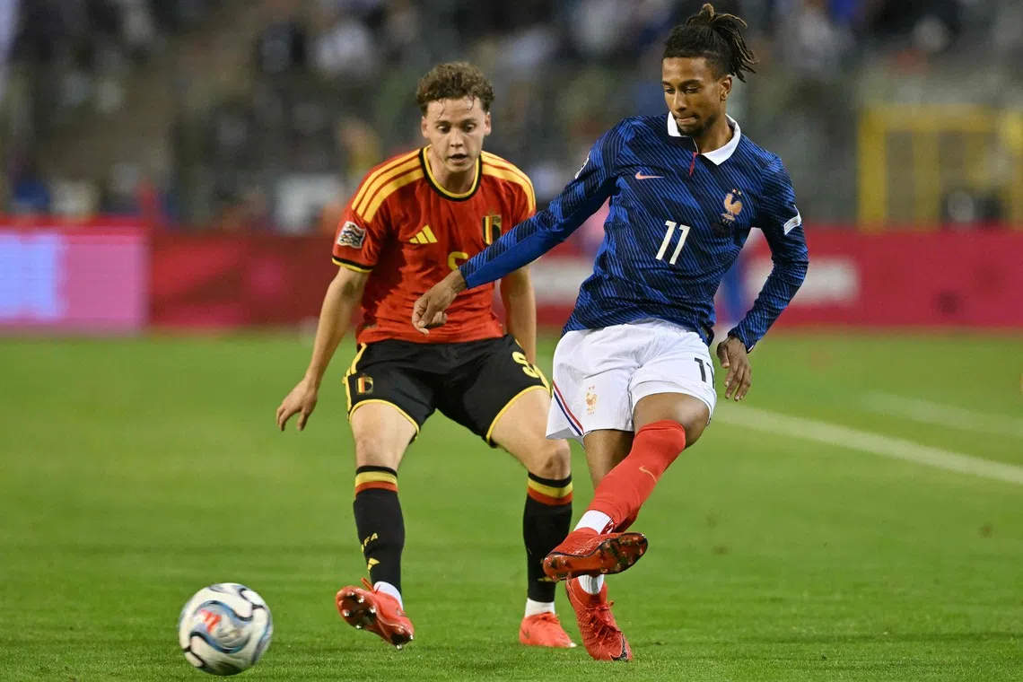 France's midfielder #11 Michael Olise (R) passes the ball in front of Belgium's defender #05 Maxim De Cuyper (L) during the UEFA Nations League Group A1 football match between Belgium and France at King Baudouin Stadium in Brussels on September 28, 2026.