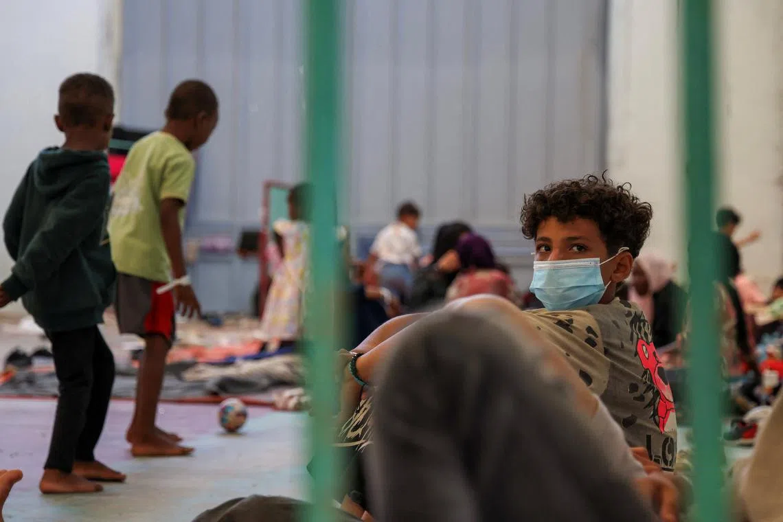 FILE PHOTO: Newly-arrived migrants are sheltered in a municipal hall, in the town of Agyia, on the island of Crete, Greece, July 10, 2025. REUTERS/Nicolas Economou/File Photo