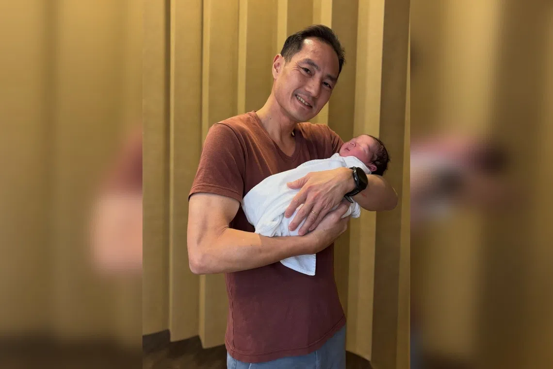 Tan Kiat How with his third child Micah.