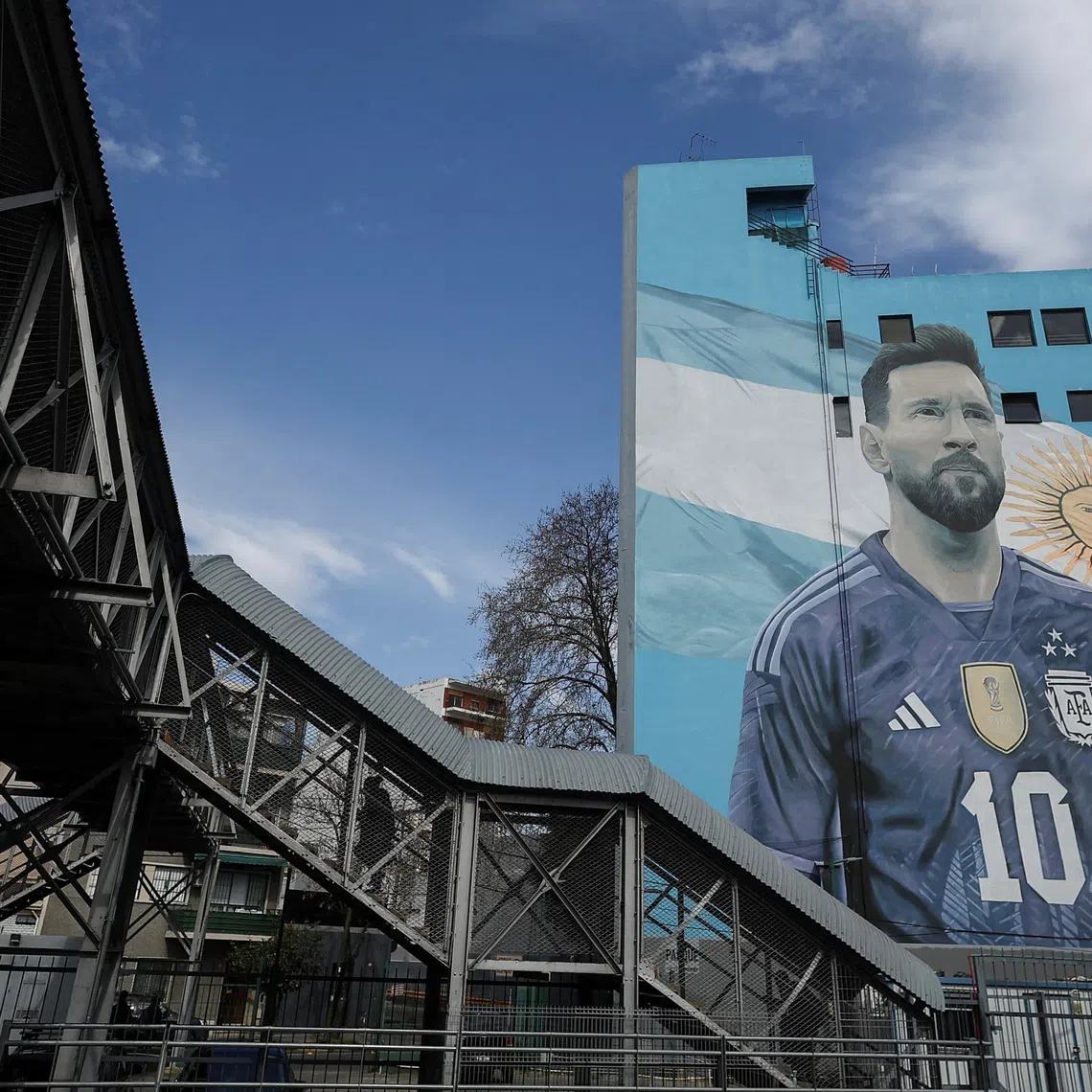 A commuter walks past a mural of Argentine soccer legend Lionel Messi, on the day he announced his retirement from the national team, at the Villa del Parque train station, in Buenos Aires, Argentina, August 31, 2026. REUTERS/Agustin Marcarian