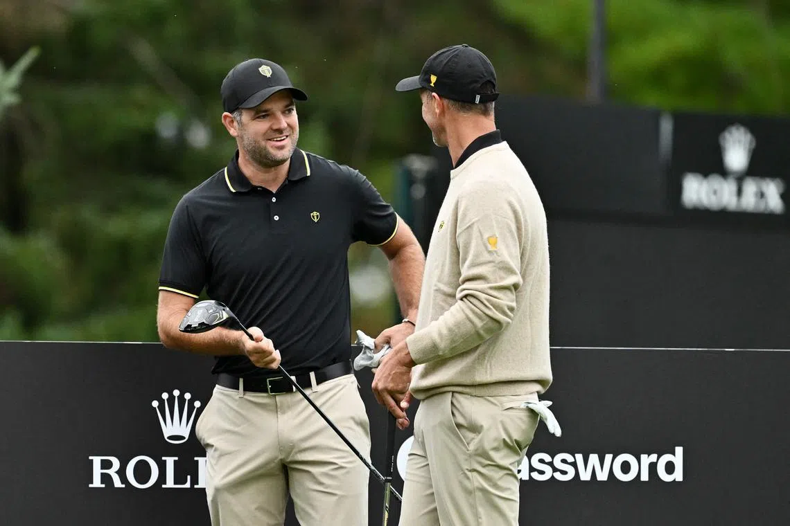 MONTREAL, QUEBEC - SEPTEMBER 24: Corey Conners of Canada and the International Team talks to Adam Scott of Australia and the International Team during a practice round prior to the 2024 Presidents Cup at The Royal Montreal Golf Club on September 24, 2024 in Montreal, Quebec, Canada.   Minas Panagiotakis/Getty Images/AFP (Photo by Minas Panagiotakis / GETTY IMAGES NORTH AMERICA / Getty Images via AFP)