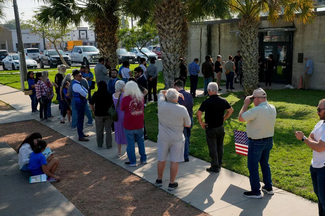 People wait in line to cast their votes during the Super Tuesday primary election in McAllen, Texas, on March 5.