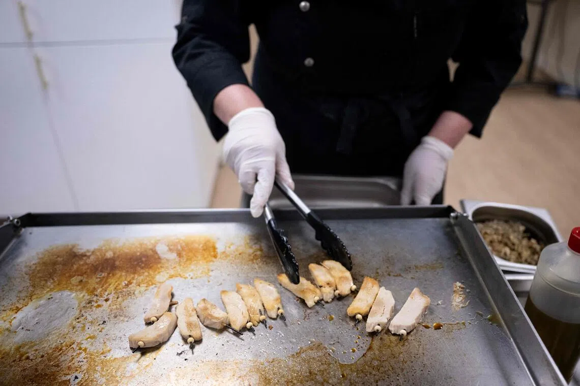 A chef cooks a plant-based meat substitute at a factory in Duppigheim, eastern France, on March 18, 2024. 