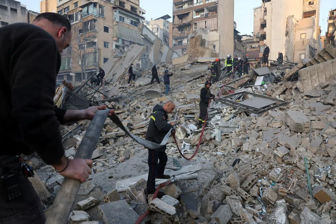 Emergency personnel work at the site of a collapsed building, in the aftermath of an Israeli strike, following an escalation between Hezbollah and Israel amid the U.S.-Israeli conflict with Iran, in central Beirut's Bachoura neighbourhood, Lebanon, March 18, 2026. REUTERS/Mohamed Azakir TPX IMAGES OF THE DAY