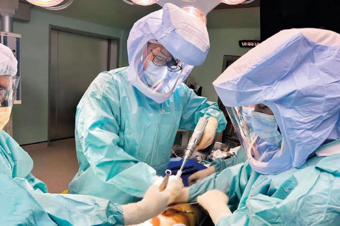 Dr Moo Ing How, a consultant at CGH’s department of orthopaedic surgery, performing a hip replacement surgery using the new method.