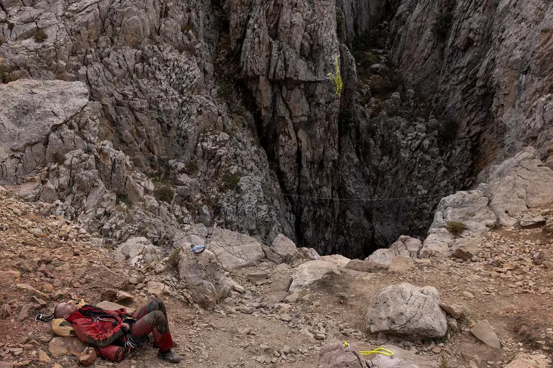 A rescuer rests at the entrance of Morca Cave as he takes part in a rescue operation to reach US caver Mark Dickey who fell ill and became trapped some 1,000 metres underground, near Anamur in Mersin province, southern Turkey, Sept 11.