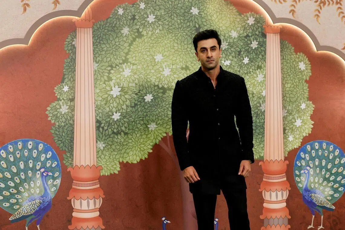 Bollywood actor Ranbir Kapoor poses for pictures on the red carpet as he attends the blessing ceremony of Anant Ambani and Radhika Merchant after their marriage in Mumbai, India, July 13, 2024.