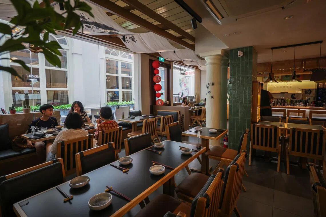 Chuan Bistro’s soft lighting, full-height glass panels and wood accents evoke the calm minimalism of a Japanese restaurant, but a closer look reveals unmistakable Chinese touches.