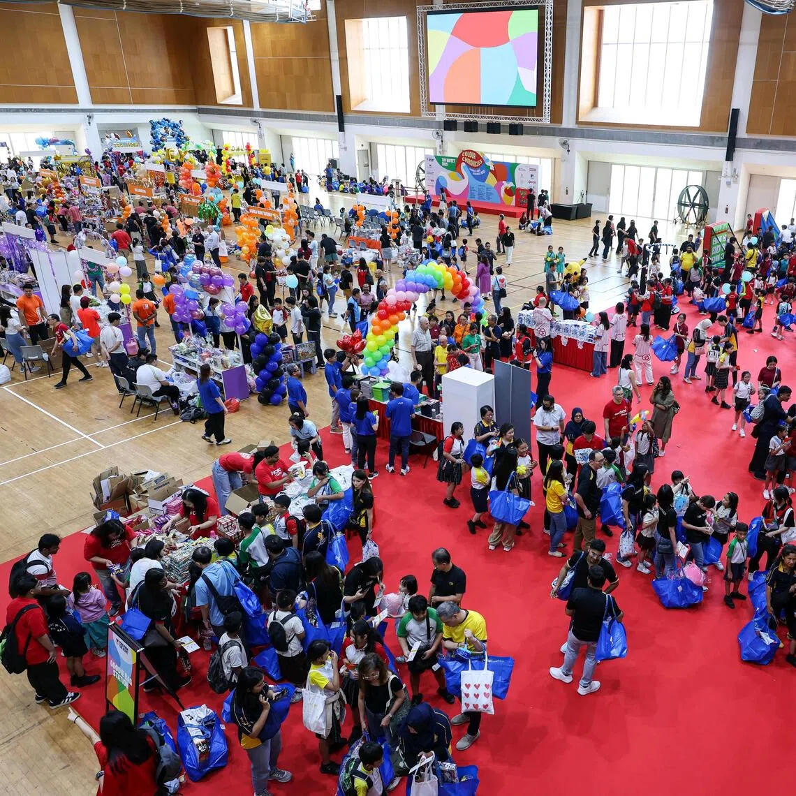 Children choosing toys and playing at game booths at the Toy Buffet at ITE College Central on Nov 14.