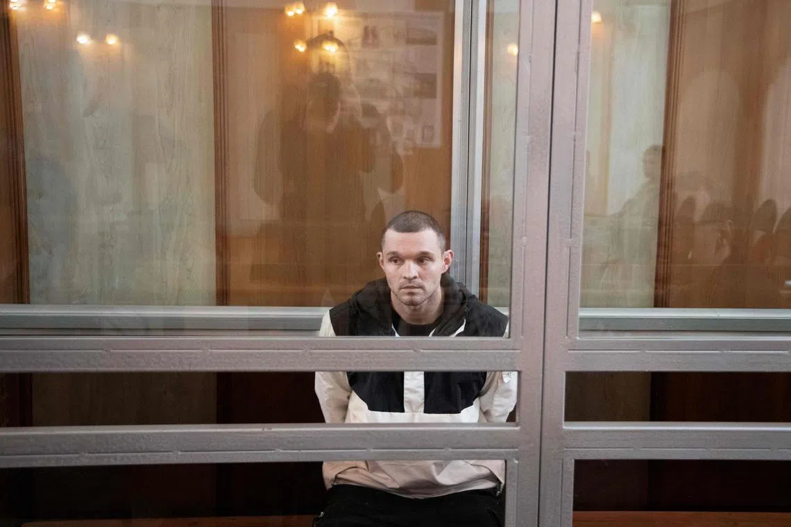 US serviceman Gordon Black sits inside a glass cage in a court in Vladivostok as his sentence is being read.