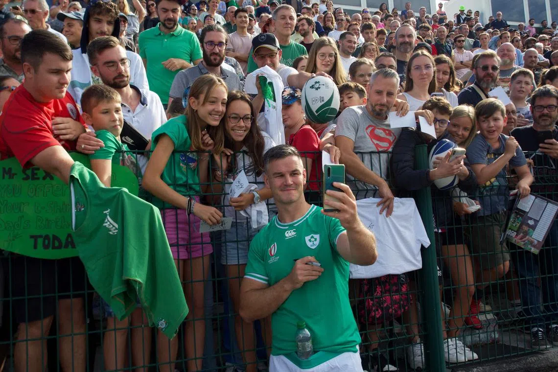 Ireland captain and fly-half Jonathan Sexton poses for a photograph with fans during a training session at the Stade de la Vallee du Cher in Tours, central France, on Sept 2.