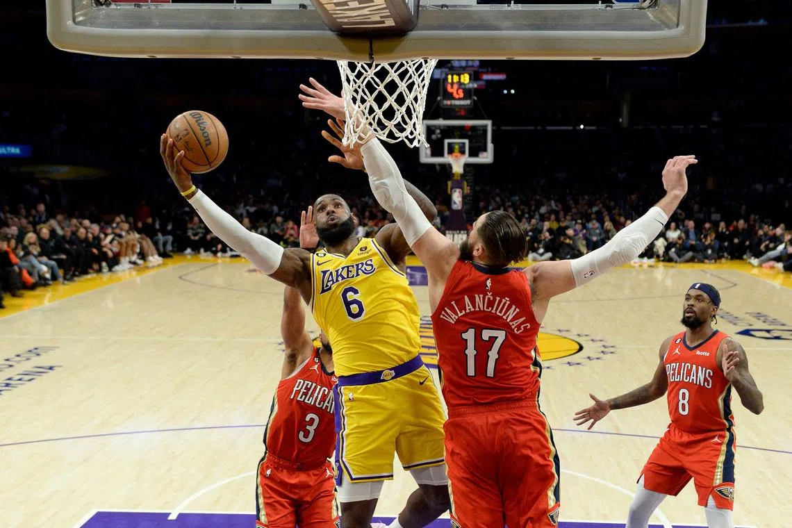 LeBron James of the Los Angeles Lakers scores against the New Orleans Pelicans' Jonas Valanciunas during the second half at Crypto.com Arena on Feb 15, 2023.